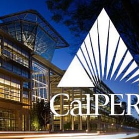 The photo shows a modern building at dusk, with large glass windows and a distinct architectural design. Prominently featured is the CalPERS logo, which includes a stylized triangle and sunburst graphic.