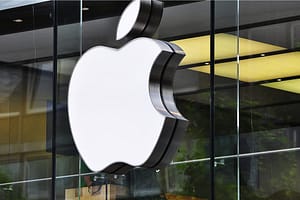 Apple logo sign on glass storefront